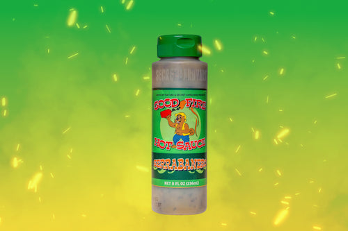Good Fire hot sauce bottle on green background